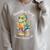 Unearth a Story Summer Reading 2026 Book Lovers Fun Raglan Sleeve Sweatshirt Heather Forest