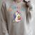 Unicorn Reading a Book Unearth a Story Program 2026 Raglan Sleeve Sweatshirt Heather Forest Unicorn Reading a Book Unearth a Story Program 2026 Raglan Sleeve Sweatshirt Heather Forest