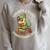 Unreath a Story Summer Library Reading 2026 Dinosaur Book Raglan Sleeve Sweatshirt Heather Forest
