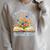 Women's New Chapter Begins Retired 2026 Watercolor Floral Book Women Raglan Sleeve Sweatshirt Heather Forest