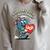 Women's Support Your Local Library Staff Retro Book Mascot Raglan Sleeve Sweatshirt Heather Forest