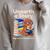 Women's Unearth A Story Reading Mammoth Prehistoric Book Librarian Raglan Sleeve Sweatshirt Heather Forest