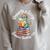Women's Unearth a Story Summer Reading 2026 Book Lover Dino Fun Raglan Sleeve Sweatshirt Heather Forest