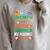 Women's Unearth A Story Summer Reading Program 2026 Dinosaur Book Raglan Sleeve Sweatshirt Heather Forest