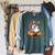Ghost Reading Book On Swing Halloween Autumn Art Raglan Sleeve Sweatshirt Heather Blue Lagoon