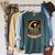 Halloween Tarot Card The Reader Skeleton Reading Books Raglan Sleeve Sweatshirt Heather Blue Lagoon