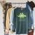 The Library Is Dino-Mite Stegosaurus Reading Kids Book Raglan Sleeve Sweatshirt Heather Blue Lagoon The Library Is Dino-Mite Stegosaurus Reading Kids Book Raglan Sleeve Sweatshirt Heather Blue Lagoon