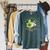 Unearth a Story Summer Reading 2026 Dinosaur Book Kids Raglan Sleeve Sweatshirt Heather Blue Lagoon Unearth a Story Summer Reading 2026 Dinosaur Book Kids Raglan Sleeve Sweatshirt Heather Blue Lagoon