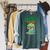Women's Unearth a Story Summer Reading 2026 Triceratops Dino Book Raglan Sleeve Sweatshirt Heather Blue Lagoon