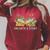 Unearth a Story Dinosaur 2026 Summer Reading Program Book Raglan Sleeve Sweatshirt Heather Dust Unearth a Story Dinosaur 2026 Summer Reading Program Book Raglan Sleeve Sweatshirt Heather Dust