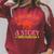 Unearth a Story Summer Reading 2026 Triceratops Dino Book Premium Tri-Blend Raglan Sleeve Sweatshirt Heather Dust