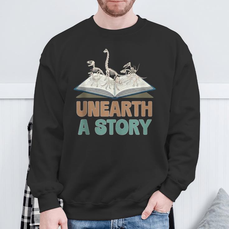Unearth A Story Skeleton Dinosaur Book Summer Reading 2026 Sweatshirt Gifts for Old Men Unearth A Story Skeleton Dinosaur Book Summer Reading 2026 Sweatshirt Gifts for Old Men