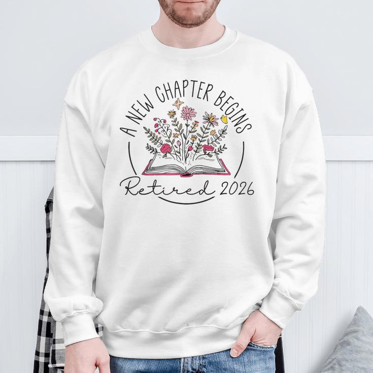 A New Chapter Retired 2026 Begins Retirement Wildflower Book Sweatshirt Gifts for Old Men A New Chapter Retired 2026 Begins Retirement Wildflower Book Sweatshirt Gifts for Old Men