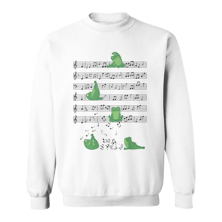 ヨガをしているかわいいカエル 音符 音記号 ミュージシャンアート 長袖tシャツ スウェットシャツ