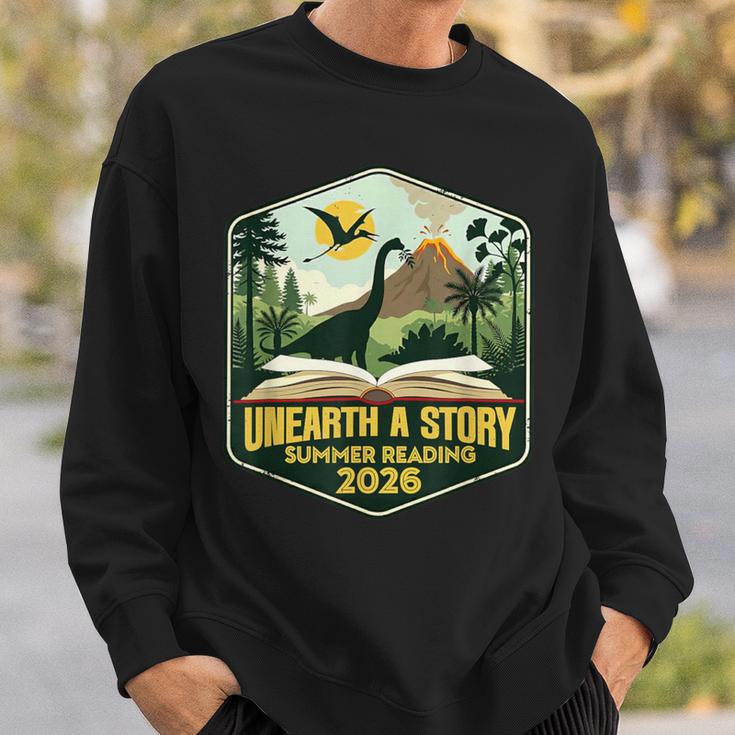 2026 Summer Reading Unearth a Story Teachers Students Book Sweatshirt Gifts for Him 2026 Summer Reading Unearth a Story Teachers Students Book Sweatshirt Gifts for Him