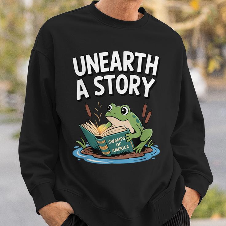 Unearth a Story Frog Reading a Book Summer 2026 Sweatshirt Gifts for Him Unearth a Story Frog Reading a Book Summer 2026 Sweatshirt Gifts for Him