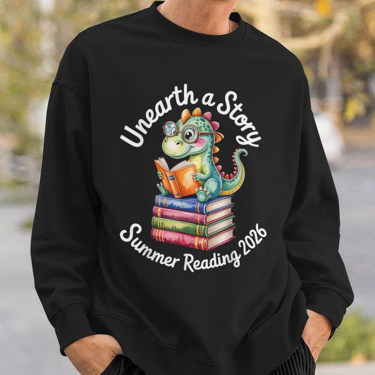 Unearth a Story Summer Reading 2026 Book Lover Dino Fun Sweatshirt Gifts for Him Unearth a Story Summer Reading 2026 Book Lover Dino Fun Sweatshirt Gifts for Him