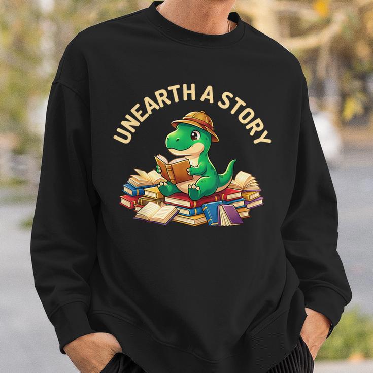 Unearth A Story Summer Reading 2026 Dinosaur Book Floral Sweatshirt Gifts for Him Unearth A Story Summer Reading 2026 Dinosaur Book Floral Sweatshirt Gifts for Him