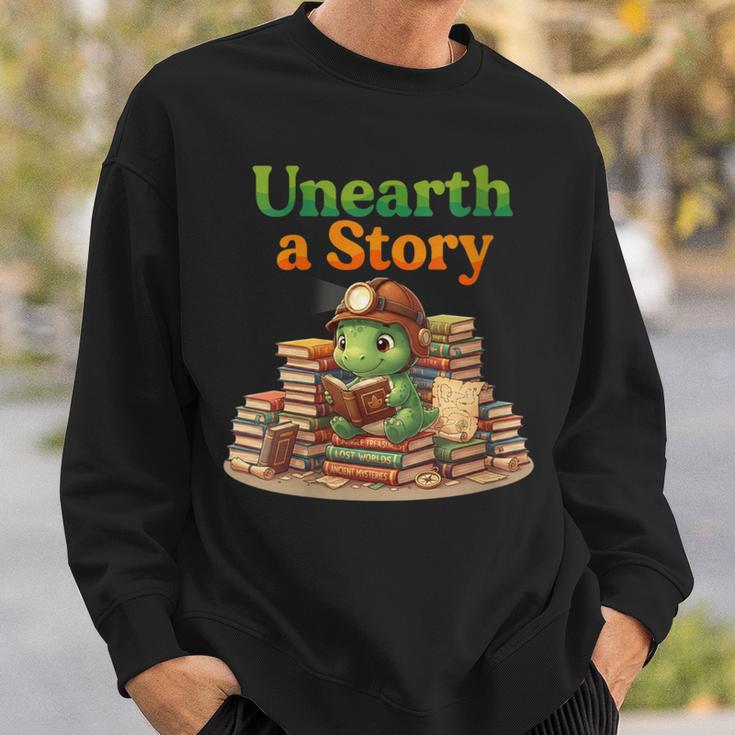 Women's Unearth a Story Summer 2026 Dinosaur Reading Books Dino Sweatshirt Gifts for Him