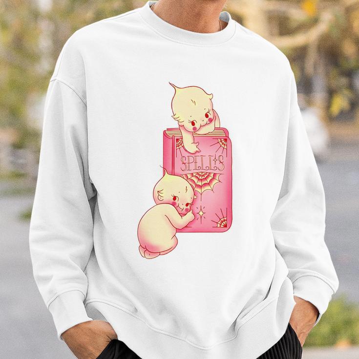 Kewpie Baby Magic Spell Book Witchcraft Halloween Gothic Sweatshirt Gifts for Him Kewpie Baby Magic Spell Book Witchcraft Halloween Gothic Sweatshirt Gifts for Him