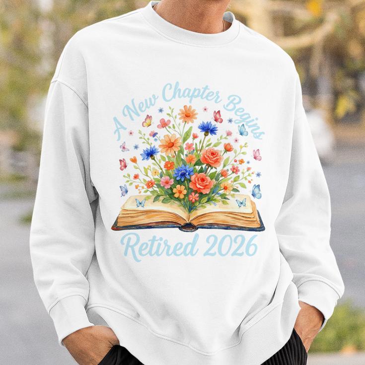 New Chapter Begins Retired 2026 Watercolor Floral Book Women Premium Tri-Blend Sweatshirt Gifts for Him
