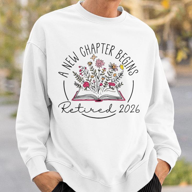 A New Chapter Retired 2026 Begins Retirement Wildflower Book Sweatshirt Gifts for Him A New Chapter Retired 2026 Begins Retirement Wildflower Book Sweatshirt Gifts for Him