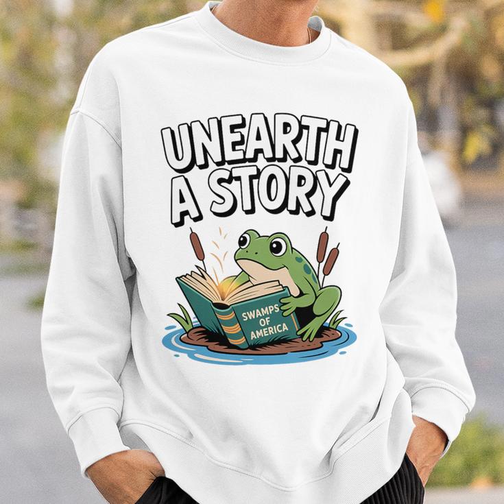 Unearth a Story Frog Reading a Book Summer 2026 Premium Tri-Blend Sweatshirt Gifts for Him