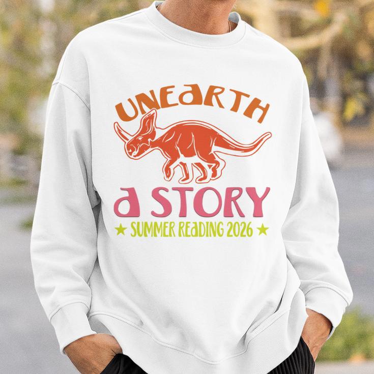 Unearth a Story Summer Reading 2026 Triceratops Dino Book Sweatshirt Gifts for Him Unearth a Story Summer Reading 2026 Triceratops Dino Book Sweatshirt Gifts for Him