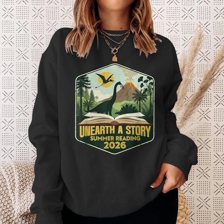 2026 Summer Reading Unearth a Story Teachers Students Book Sweatshirt Gifts for Her 2026 Summer Reading Unearth a Story Teachers Students Book Sweatshirt Gifts for Her