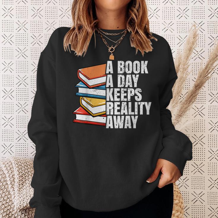 A Book A Day Keeps Reality Away Bookworm Sweatshirt Gifts for Her