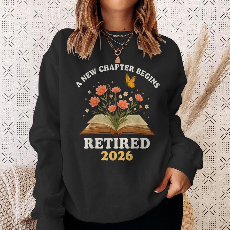 A New Chapter Begins Retired 2026 Floral Book Butterfly Tee Sweatshirt Gifts for Her