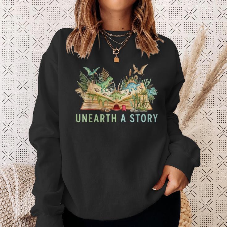 Unearth a Story Dinosaur 2026 Summer Reading Program Book Sweatshirt Gifts for Her Unearth a Story Dinosaur 2026 Summer Reading Program Book Sweatshirt Gifts for Her