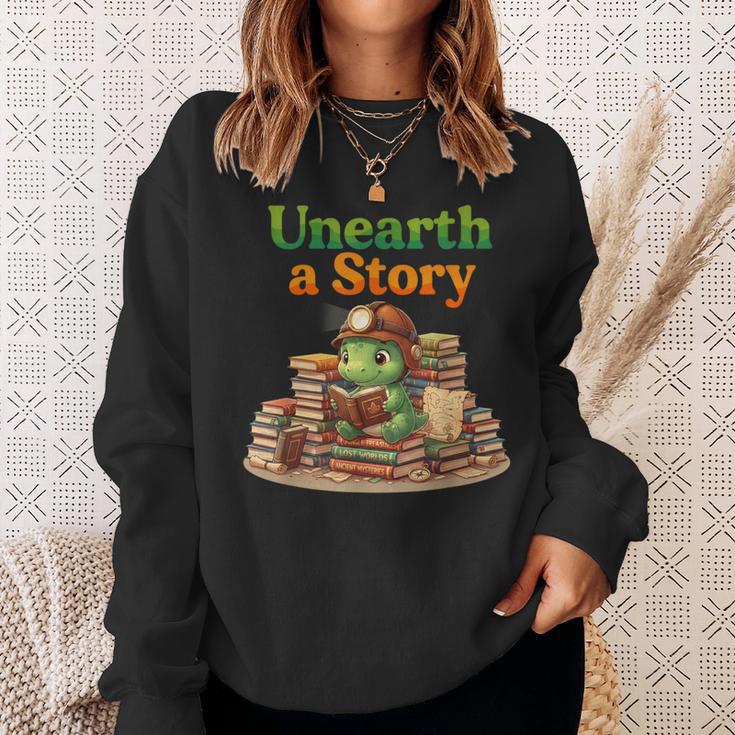 Unearth a Story Summer 2026 Dinosaur Reading Books Dino Sweatshirt Gifts for Her Unearth a Story Summer 2026 Dinosaur Reading Books Dino Sweatshirt Gifts for Her