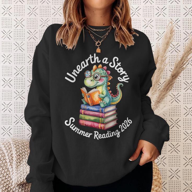 Unearth a Story Summer Reading 2026 Book Lover Dino Fun Sweatshirt Gifts for Her Unearth a Story Summer Reading 2026 Book Lover Dino Fun Sweatshirt Gifts for Her