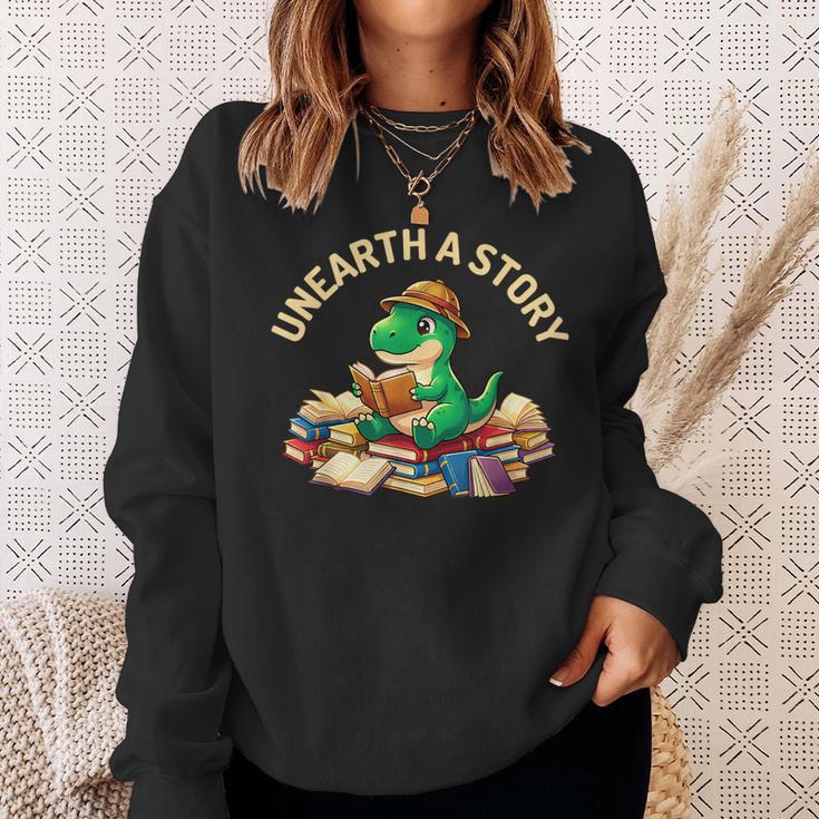 Unearth A Story Summer Reading 2026 Dinosaur Book Floral Sweatshirt Gifts for Her Unearth A Story Summer Reading 2026 Dinosaur Book Floral Sweatshirt Gifts for Her
