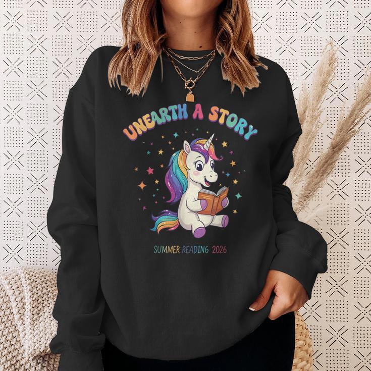 Unicorn Reading a Book Unearth a Story Program 2026 Sweatshirt Gifts for Her Unicorn Reading a Book Unearth a Story Program 2026 Sweatshirt Gifts for Her