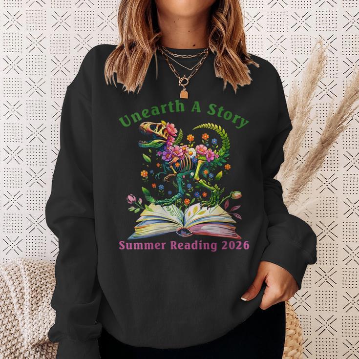 Women's Unearth A Story Summer Reading 2026 Dinosaur Book Floral Sweatshirt Gifts for Her