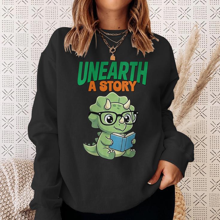 Women's Unearth a Story Summer Reading 2026 Triceratops Dino Book Sweatshirt Gifts for Her