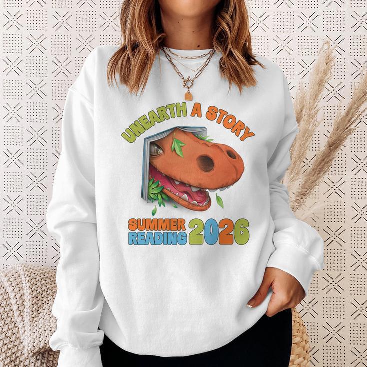 Unearth A Story Summer Reading 2026 Dinosaur Book Lover Dino Premium Tri-Blend Sweatshirt Gifts for Her