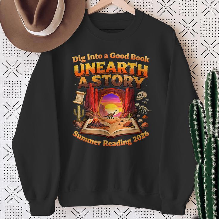 Books Summer Reading 2026 Unearth A Story Dinosaur Sweatshirt Gifts for Old Women