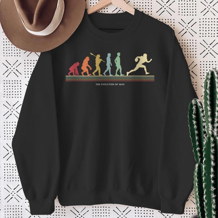 The Evolution Of Man アメリカンフットボール選手 スウェットシャツ 年配の女性への贈り物