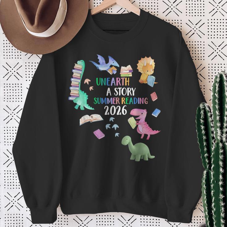 Unearth a Story Dinosaur Book 2026 Summer Reading Program Sweatshirt Gifts for Old Women Unearth a Story Dinosaur Book 2026 Summer Reading Program Sweatshirt Gifts for Old Women