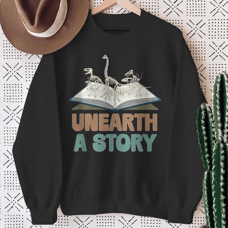Unearth A Story Skeleton Dinosaur Book Summer Reading 2026 Sweatshirt Gifts for Old Women Unearth A Story Skeleton Dinosaur Book Summer Reading 2026 Sweatshirt Gifts for Old Women