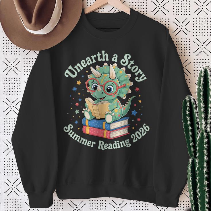 Unearth a Story Summer Reading 2026 Cute Dinosaur Book Lover Sweatshirt Gifts for Old Women
