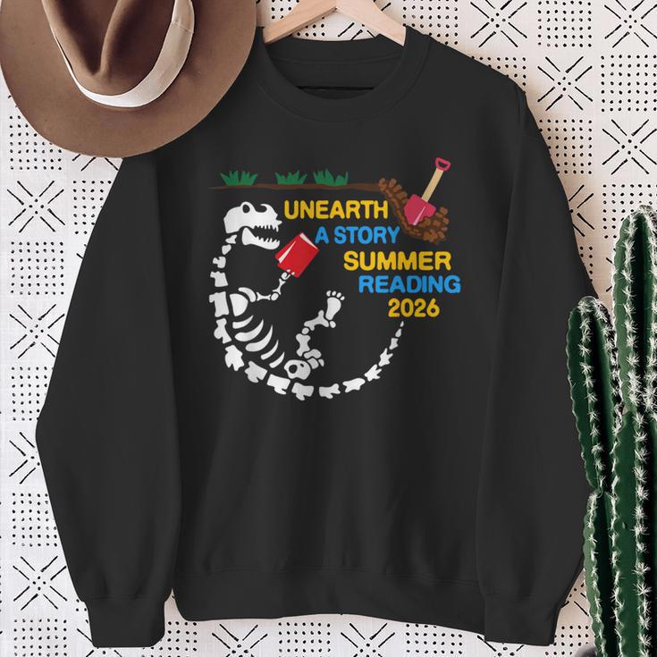 Unearth a Story T-Rex Reading a Book Summer Reading 2026 Sweatshirt Gifts for Old Women Unearth a Story T-Rex Reading a Book Summer Reading 2026 Sweatshirt Gifts for Old Women