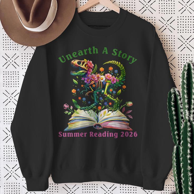 Women's Unearth A Story Summer Reading 2026 Dinosaur Book Floral Sweatshirt Gifts for Old Women