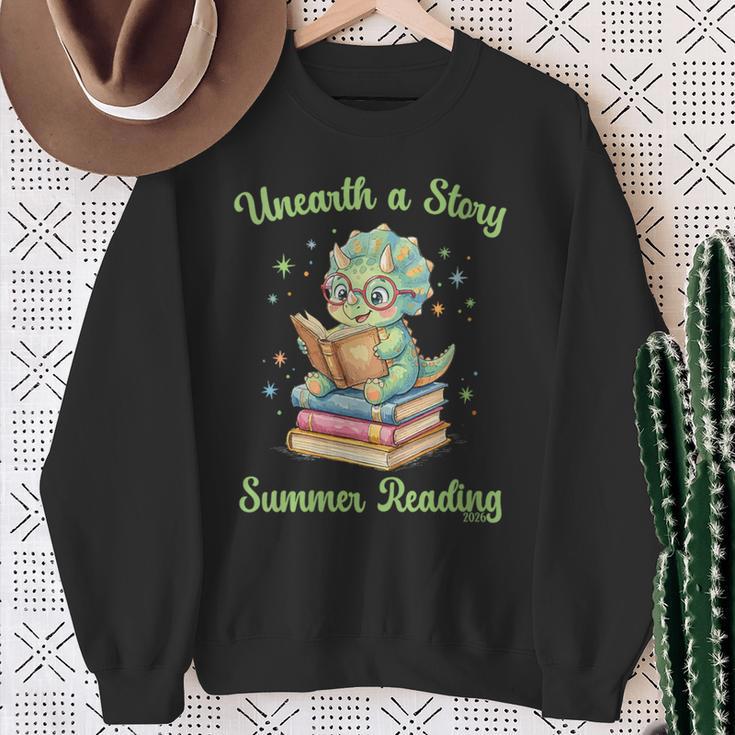 Women's Unearth a Story Triceratops Dinosaur Reading Books Cute Dino Sweatshirt Gifts for Old Women