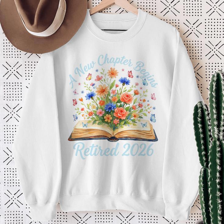 New Chapter Begins Retired 2026 Watercolor Floral Book Women Premium Tri-Blend Sweatshirt Gifts for Old Women