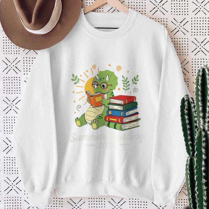 Unearth a Story Triceratops Dinosaur Reading Books Cute Dino Premium Tri-Blend Sweatshirt Gifts for Old Women