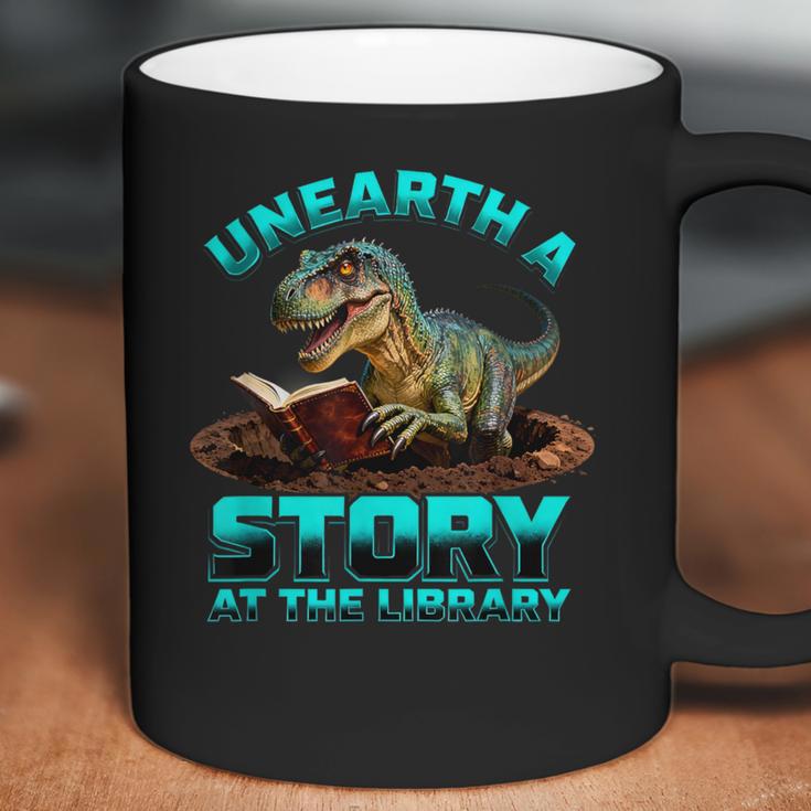 Unearth A Story At The Library Dinosaur Reading Coffee Mug Unearth A Story At The Library Dinosaur Reading Coffee Mug